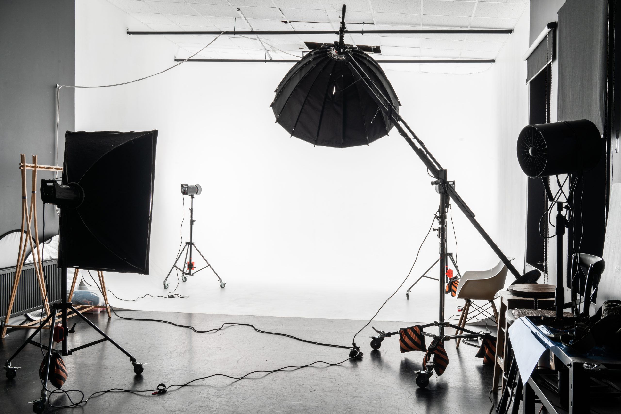 Professional camera, portrait lens, memory cards, and photography accessories prepared for a studio session