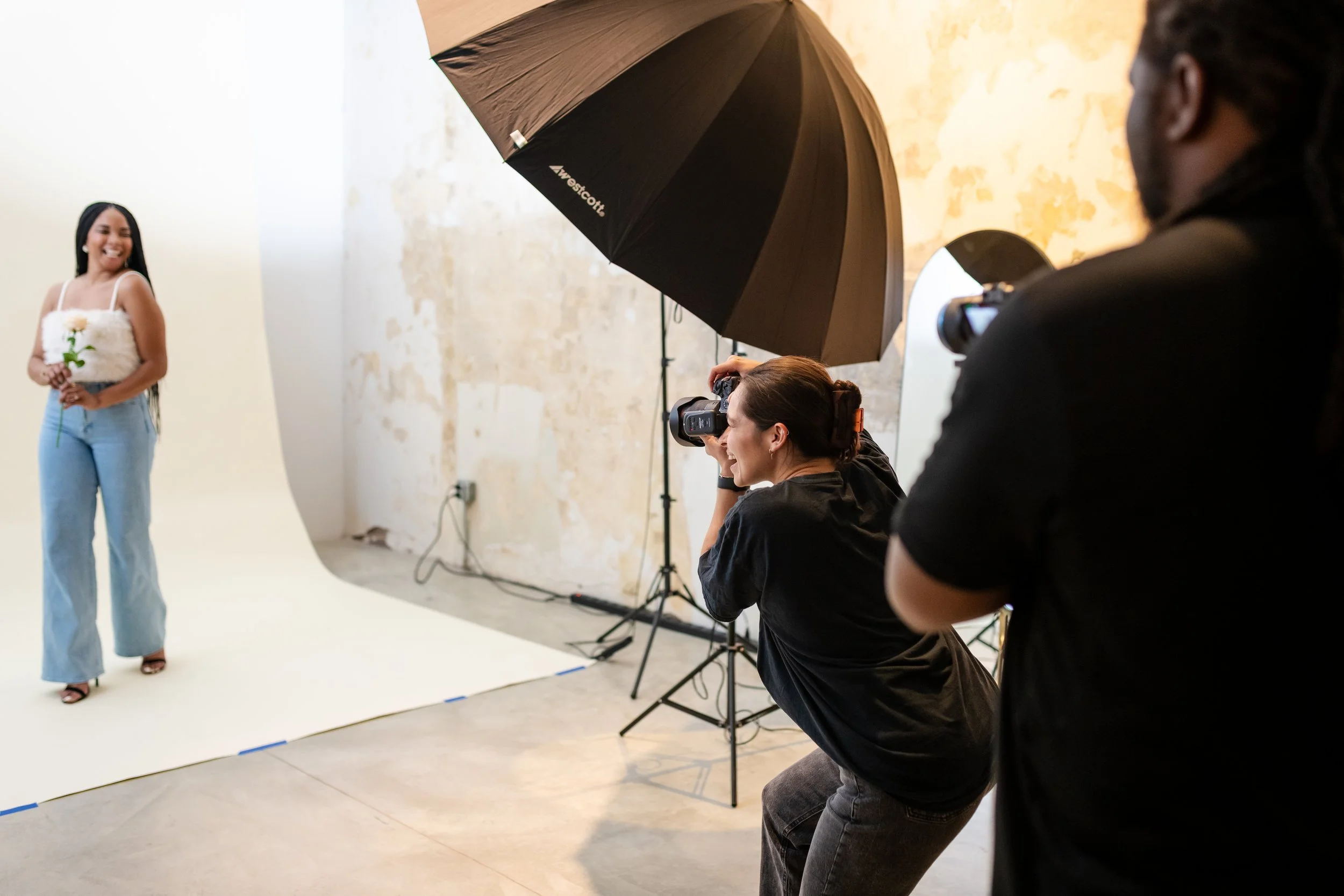 Professional photography studio arranged for a creative portrait session with studio lighting and camera equipment